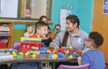y staff and kids playing with legos