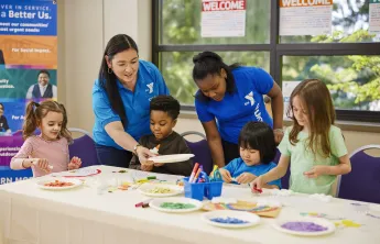 Y staff members helping youth in afterschool program