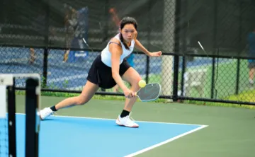 image of a woman playing pickleball