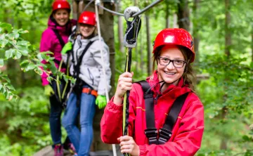 image of young female on ropes course