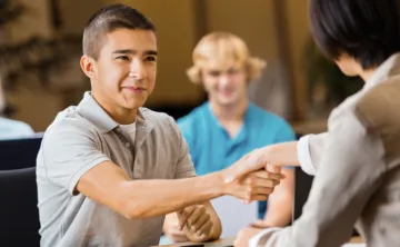 male teen shaking hands with employer