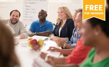 a group of people sitting around a table together