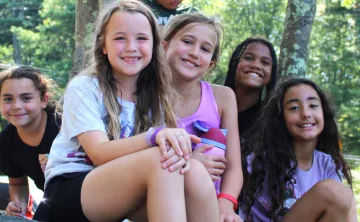 group photo of girls sitting outside and smiling