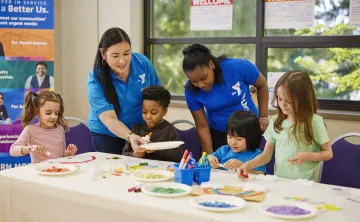 Y staff members helping youth in afterschool program