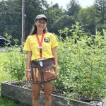 Y staff member standing outside in the garden