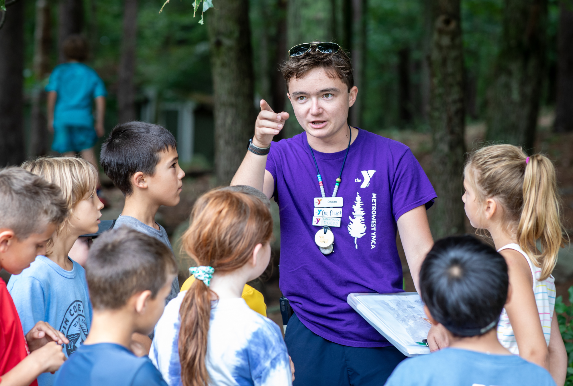 Counselor leads the middler campers through a nature walk