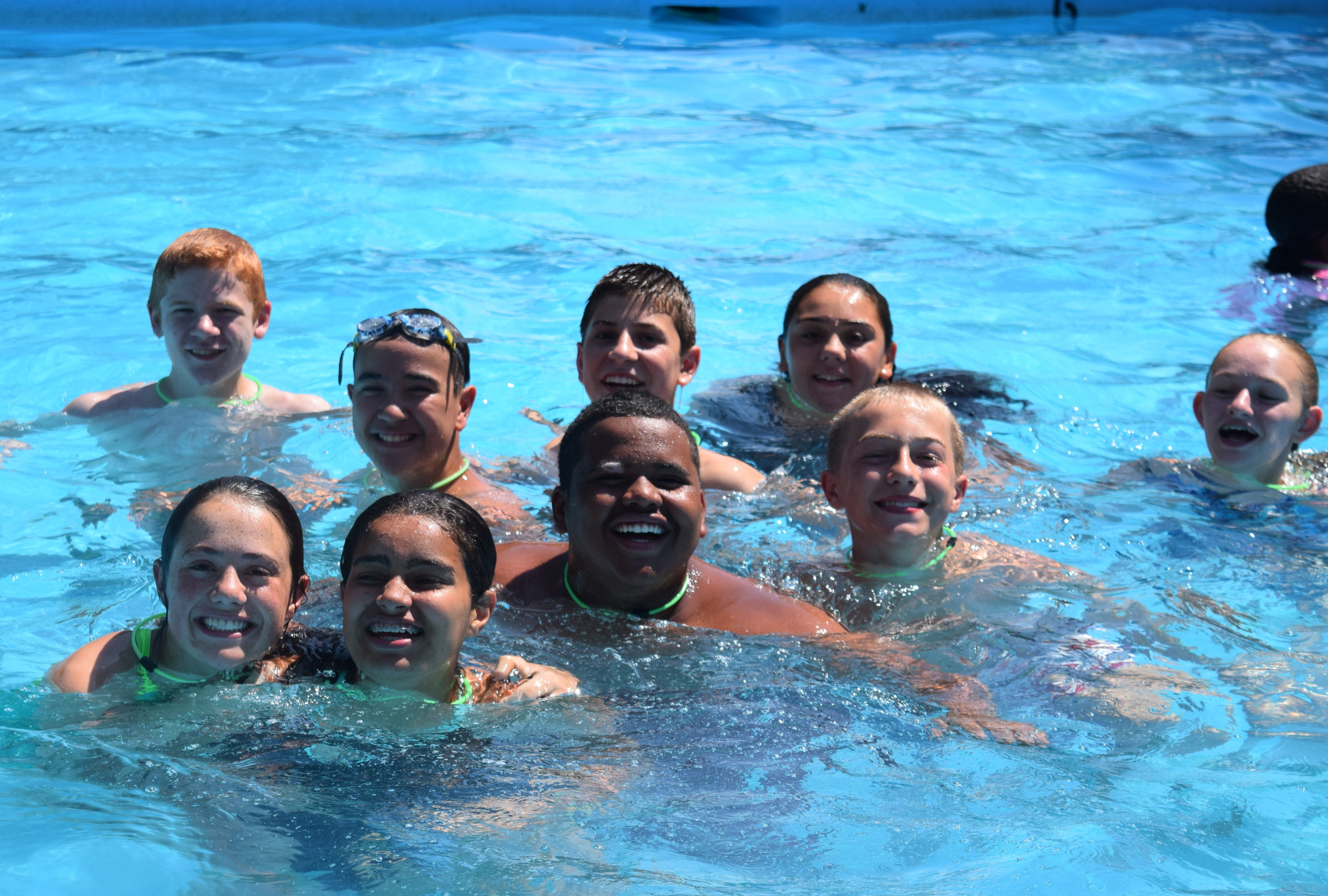 group of senior campers enjoying a dip in the outdoor pool