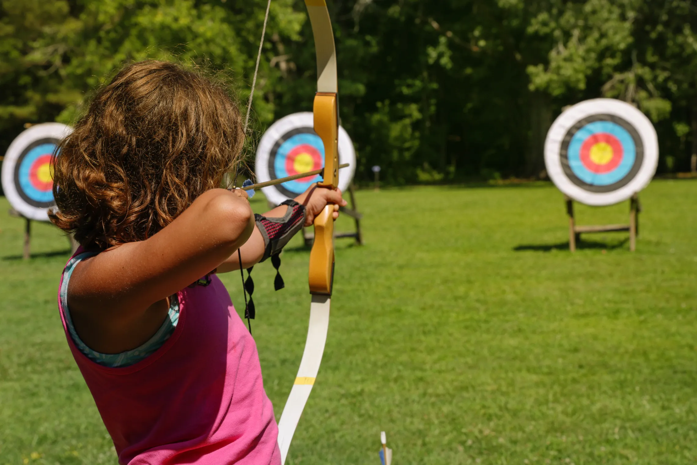 girl outside at archery range