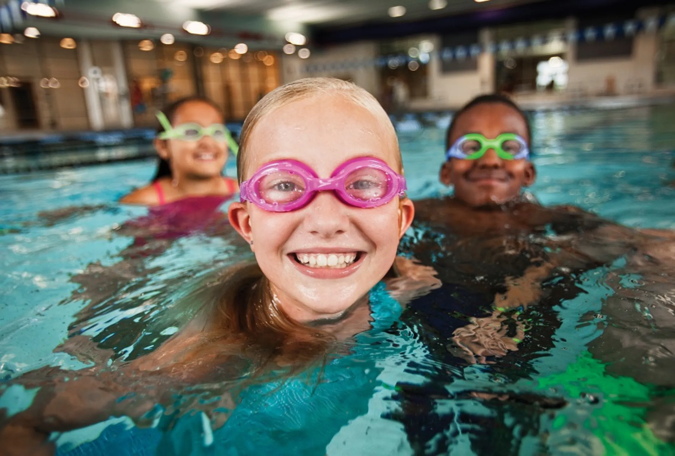 youth swimmers in pool wearing goggles